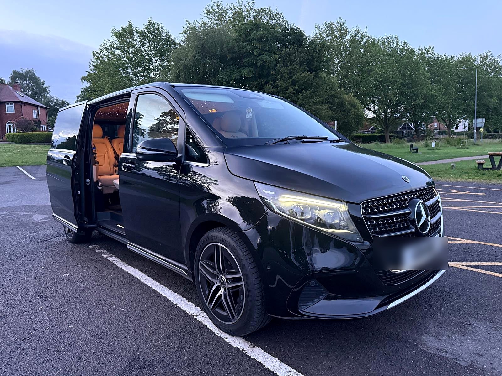 Mercedes-Benz V-Class with the passenger door open showing the private cabin used for cricket player transfers