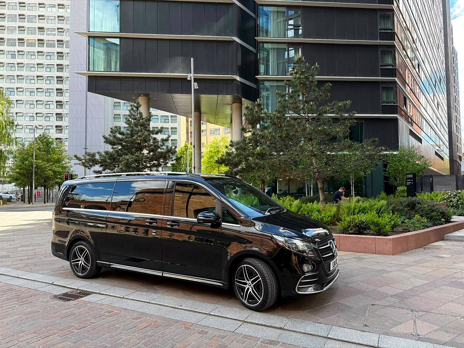 Black Mercedes-Benz V-Class in side profile outside a UK venue during The Hundred