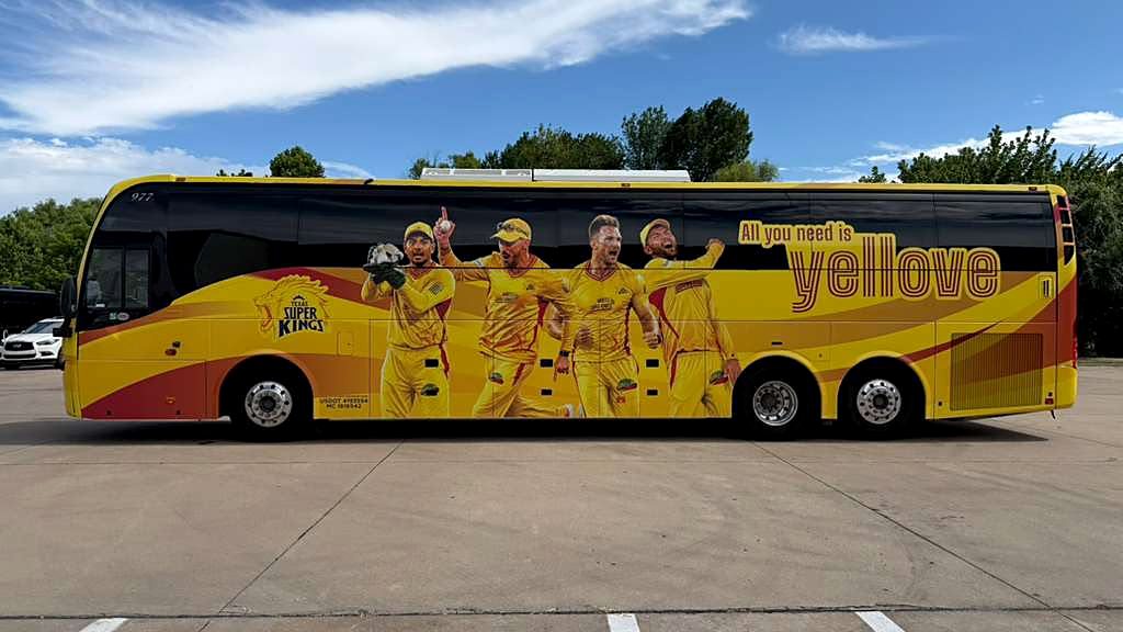 Full-length vehicle wrap along the side of the MLC franchise team coach, showing players and team slogan